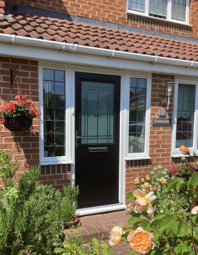 black entrance door with large frosted glass window