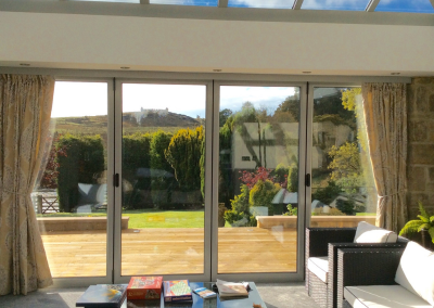 white bi fold doors overlooking garden area