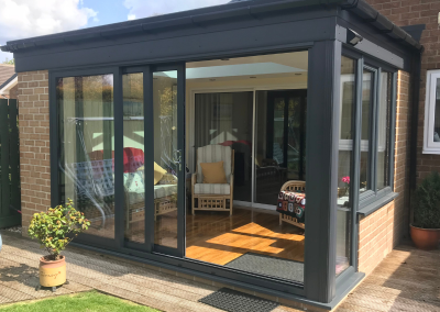 sunroom featuring large black sliding doors