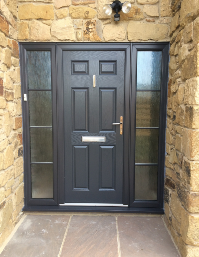 modern black entrance door with frosted glass windows either side of the entrance