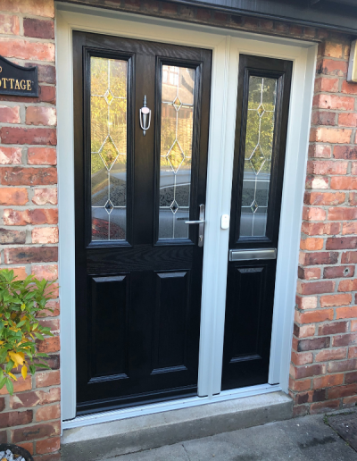 black entrance door with stained glass windows