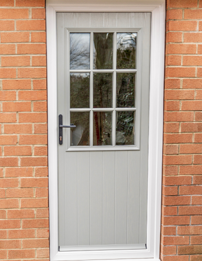 grey entrance door with 9 small windows