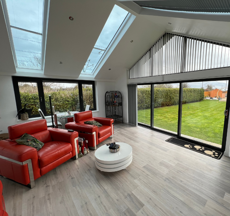 Sunroom with 2 skylights and large windows all the way round the room