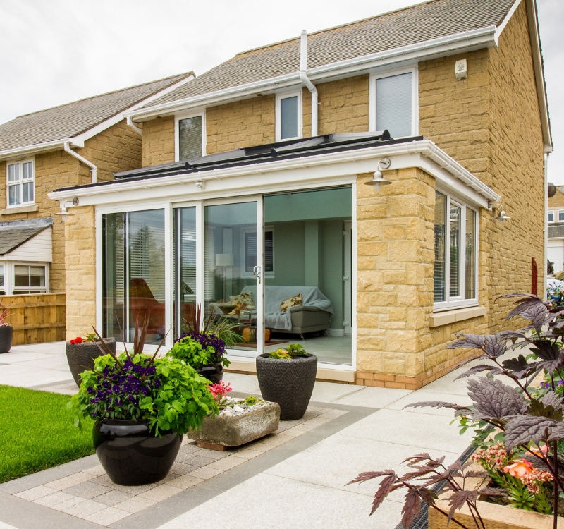 Hawthorns Windows sunroom with large sliding doors attached to family home