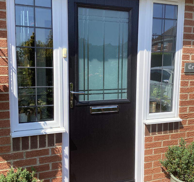 black entrance door with large frosted window