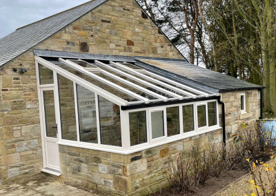 small conservatory with windows throughout the structure