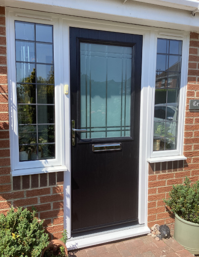 black entrance door with large frosted glass window