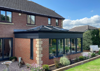 large sunroom looking out onto a garden filled with plants