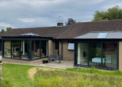 2 large sunrooms on the back of a bungalow