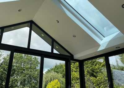 The inside of a sunroom with a skylight from another perspective