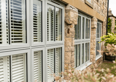 a wall of windows in a sandstone brick building