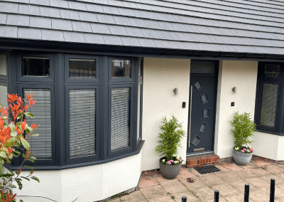 two bay window sections and a door on a modern cottage