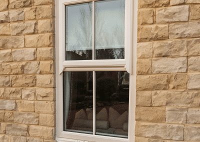 A window in a sandstone brick wall