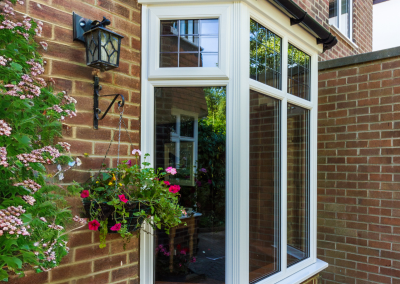 A bay window with a planter and guttering